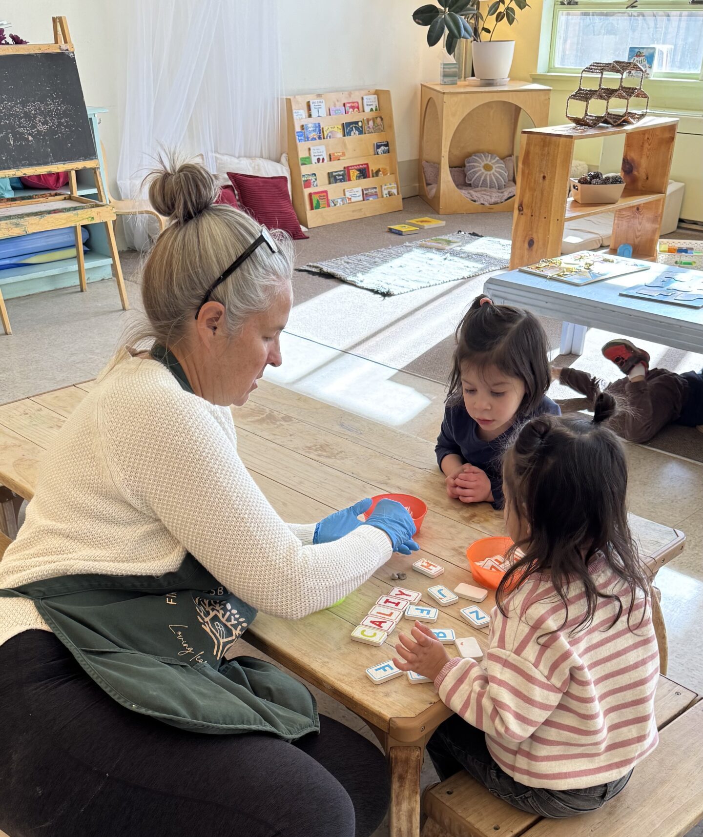 First Pres teacher working alongside children