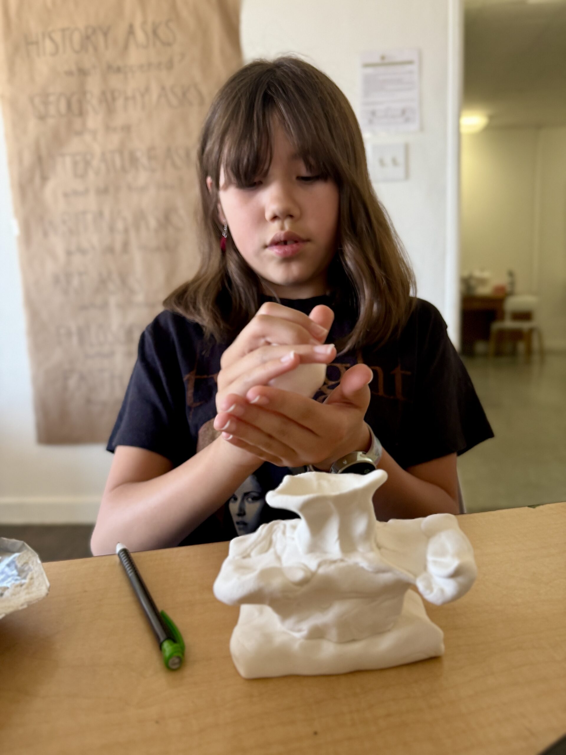 A Willows student shaping clay for a hands-on project