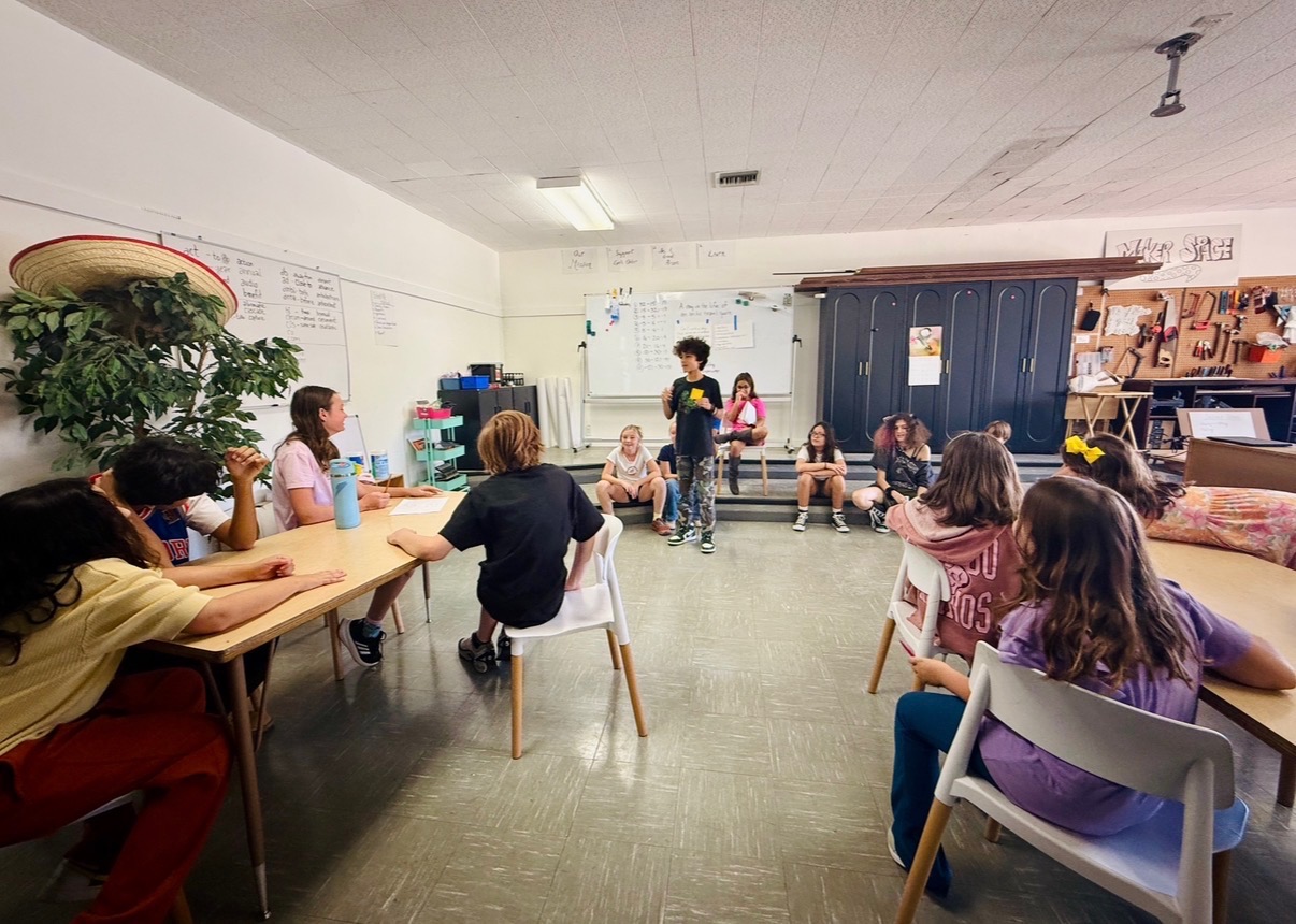 First Pres middle school students sharing ideas during a classroom discussion