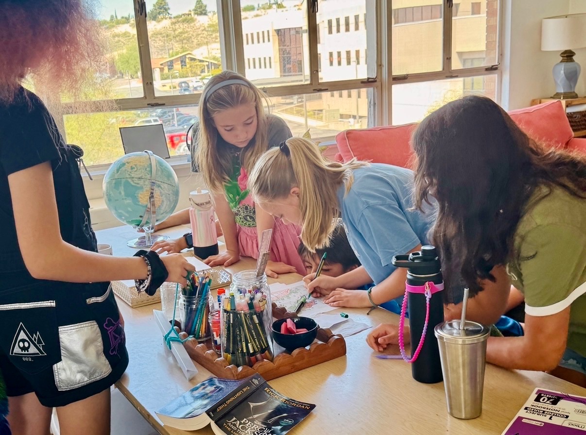 Older First Pres students drawing and working together around a table
