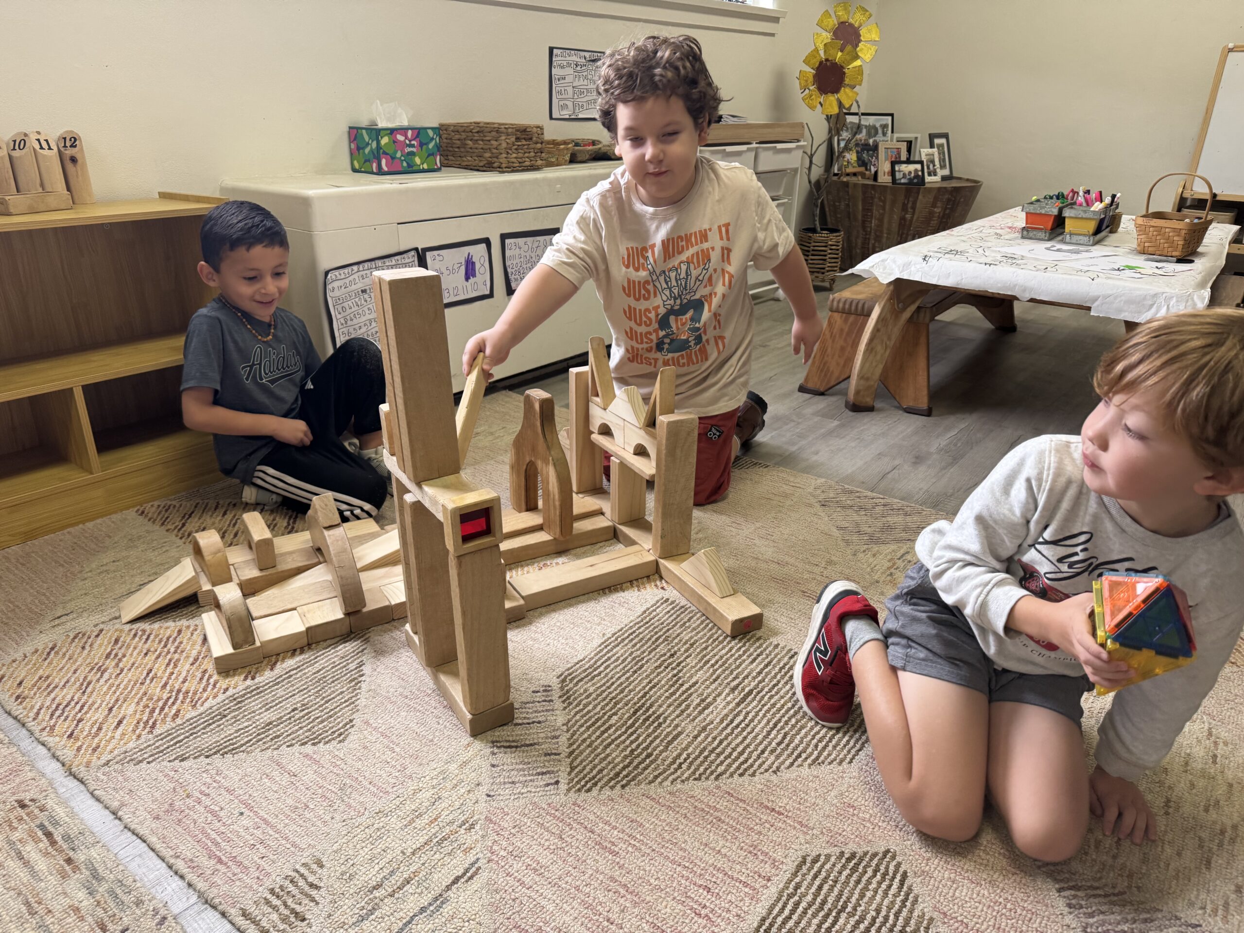 Kindergarten children collaborating on a wooden-block construction