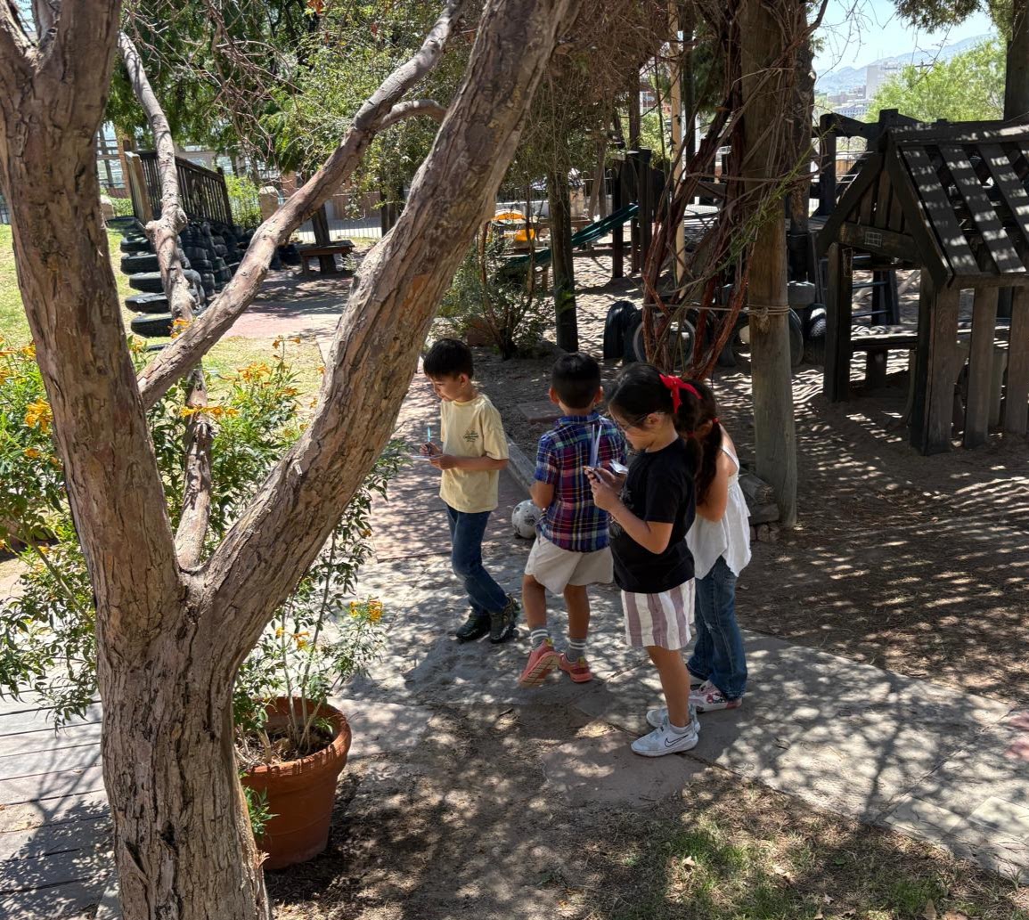 Children exploring the shaded outdoor play area
